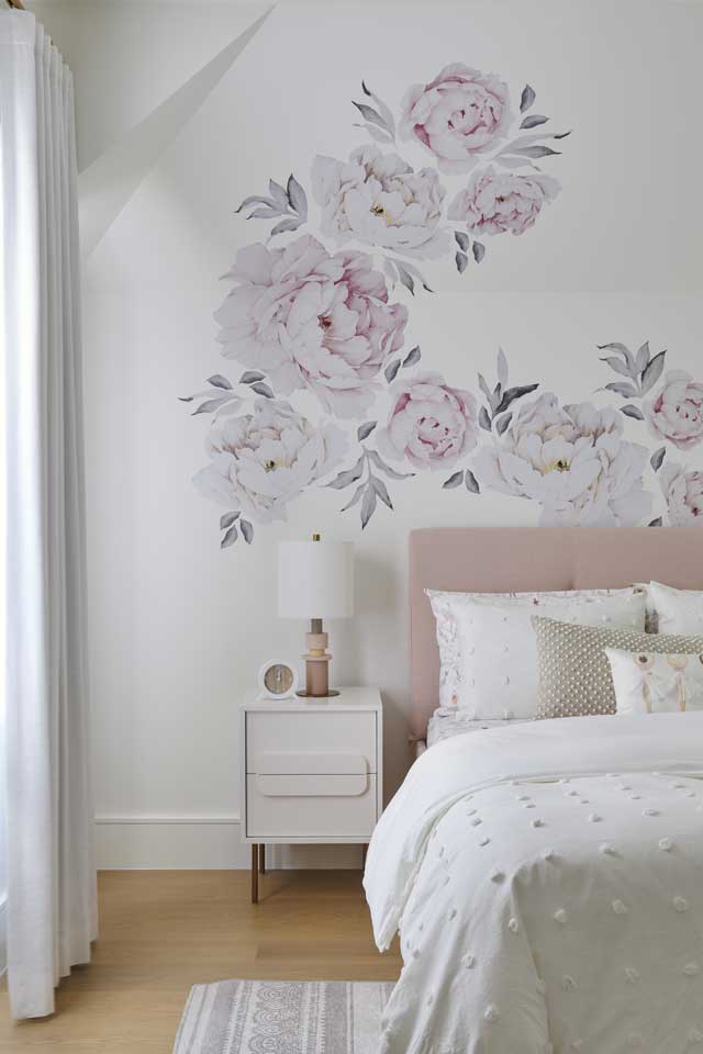children's bedroom with floral wallpaper and light pink accents